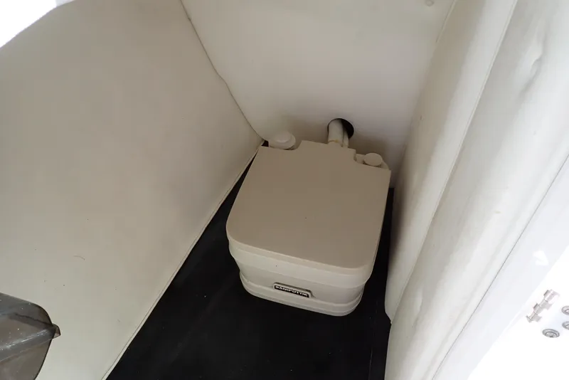 Slide: The Image of Portable toilet inside a 2002 Cobalt 240 boat compartment. - 10