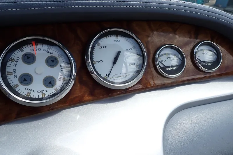 Slide: The Image of Dashboard of a 2002 Cobalt 240 boat with speedometer and gauges. - 13