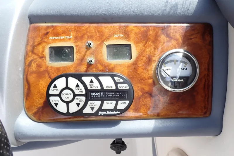 Slide: The Image of Control panel of a 2002 Cobalt 240 boat with depth and trim gauges. - 14