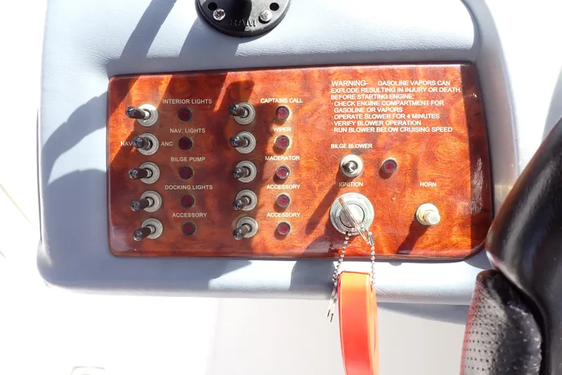 Slide: The Image of Control panel of a 2002 Cobalt 240 boat with switches and ignition key. - 15