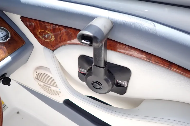 Slide: The Image of Interior of 2002 Cobalt 240 boat with control lever and wood accents. - 17