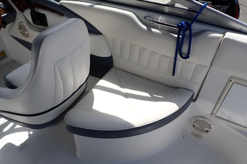 Slide: The Image of Interior seating of a 2002 Cobalt 240 boat, featuring white and gray upholstery. - 24