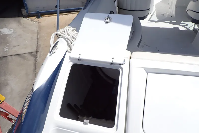 Slide: The Image of Open storage compartment on a 2002 Cobalt 240 boat deck. - 28