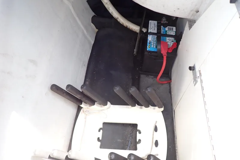 Slide: The Image of Battery compartment of a 2002 Cobalt 240 boat, featuring a secured battery and wiring. - 29