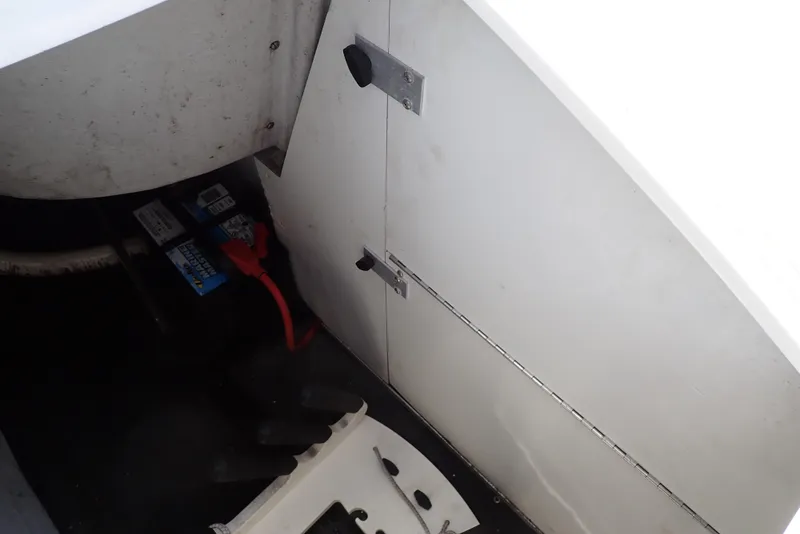 Slide: The Image of 2002 Cobalt 240 boat interior showing battery compartment and storage area. - 31