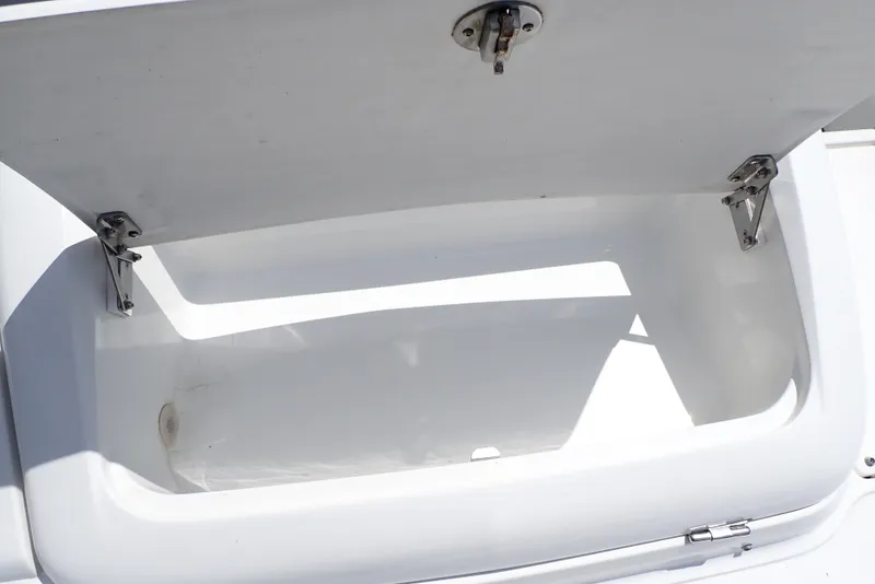 Slide: The Image of Open storage compartment on a 2002 Cobalt 240 boat. - 33