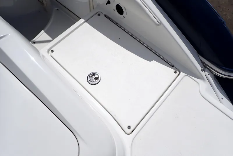 Slide: The Image of 2002 Cobalt 240 boat deck with storage compartment. - 34