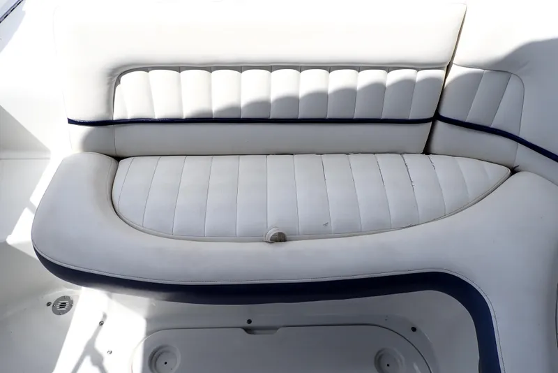 Slide: The Image of White leather seating on a 2002 Cobalt 240 boat, featuring blue accents. - 39