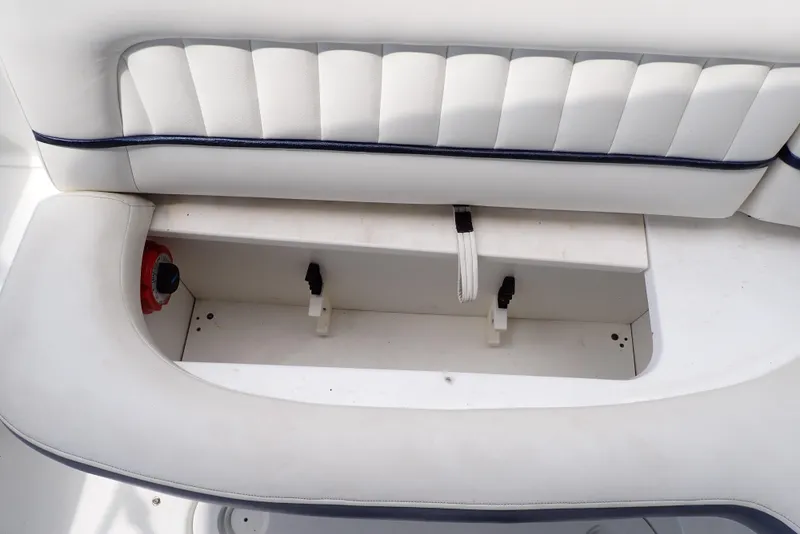 Slide: The Image of White seating storage compartment on a 2002 Cobalt 240 boat. - 40