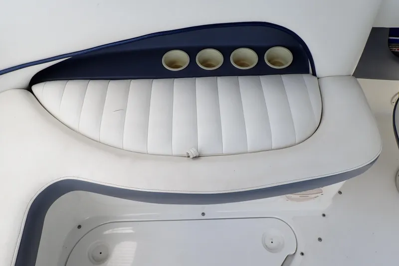 Slide: The Image of White cushioned seating with cup holders on a 2002 Cobalt 240 boat. - 41