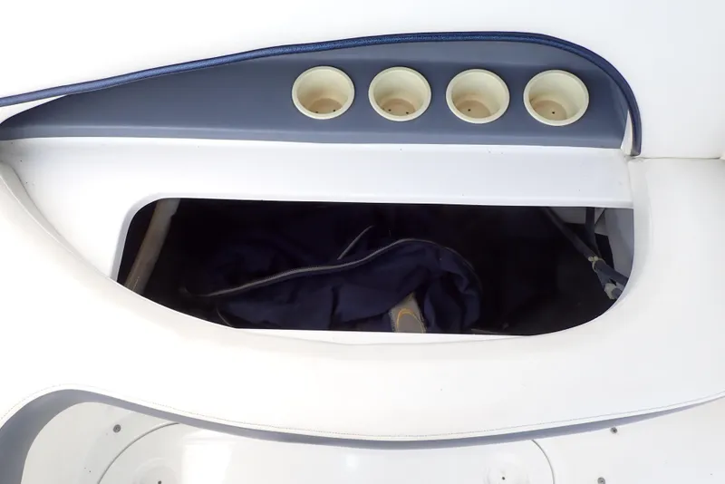 Slide: The Image of Storage compartment with cup holders on a 2002 Cobalt 240 boat. - 42