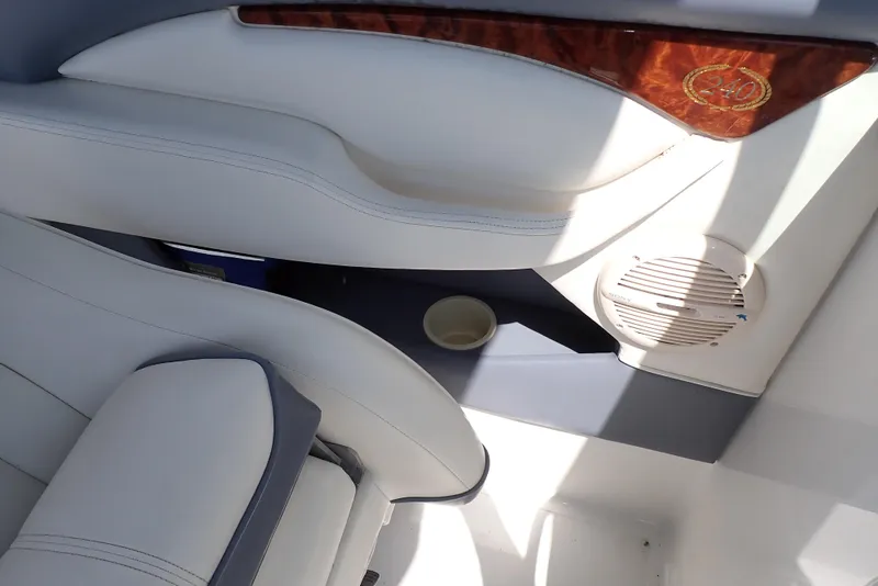 Slide: The Image of Interior of a 2002 Cobalt 240 boat with white seating and wood accents. - 43