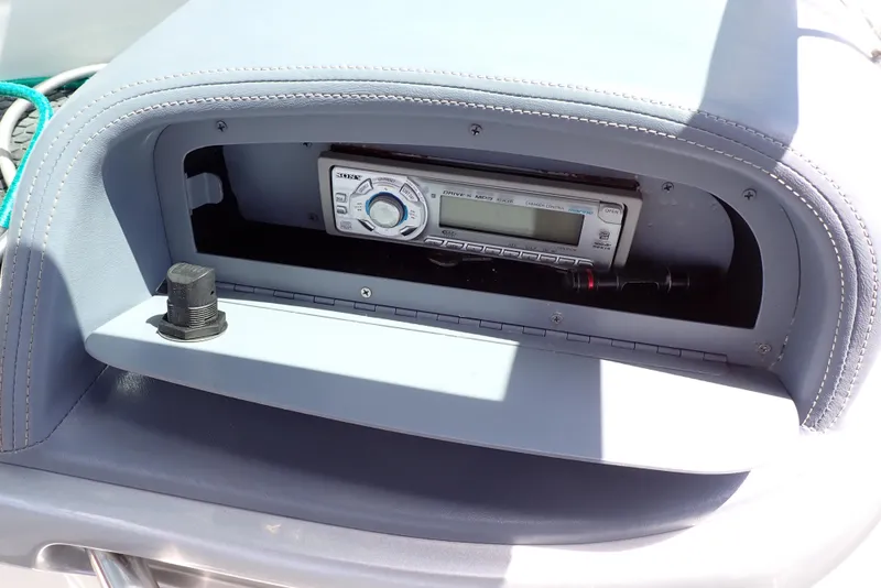 Slide: The Image of 2002 Cobalt 240 boat dashboard with stereo system in compartment. - 45