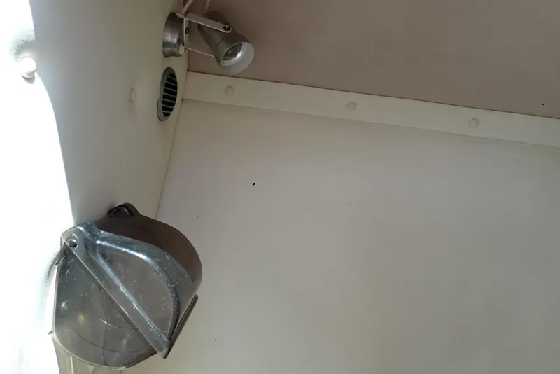 Slide: The Image of Interior of a 2002 Cobalt 240 boat showing a light fixture and ventilation. - 49