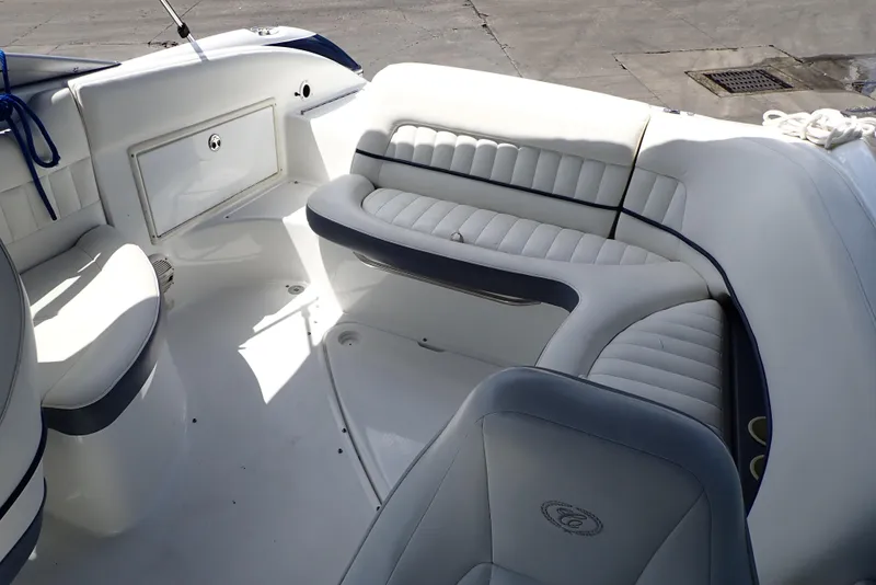 Slide: The Image of Interior of a 2002 Cobalt 240 boat with white cushioned seating. - 5