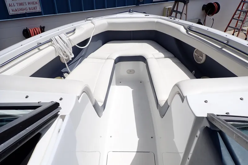 Slide: The Image of 2002 Cobalt 240 boat interior with white seating and clean deck. - 7