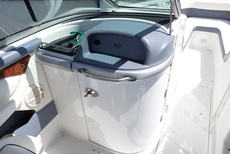 Slide: The Image of 2002 Cobalt 240 boat interior with storage compartment and seating area. - 9