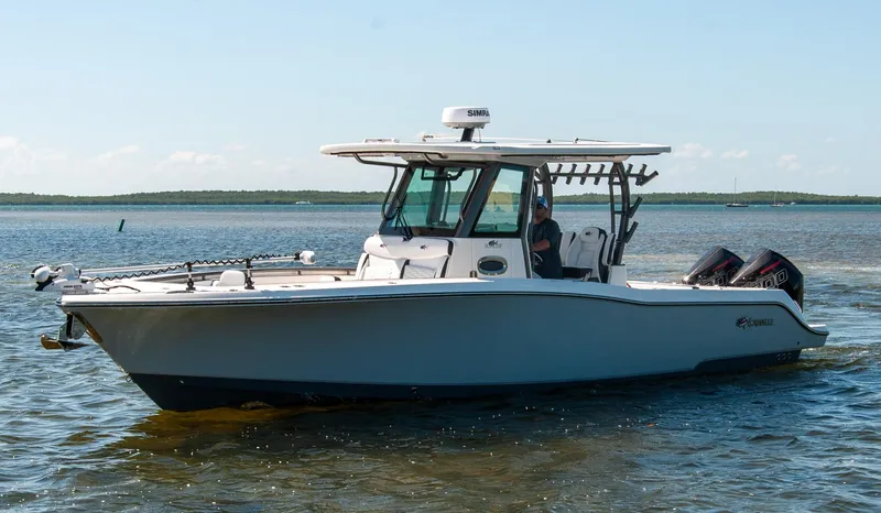 Slide: The Image of 2023 Crevalle 33 CSF boat on calm water, featuring dual engines and a sleek design. - 0