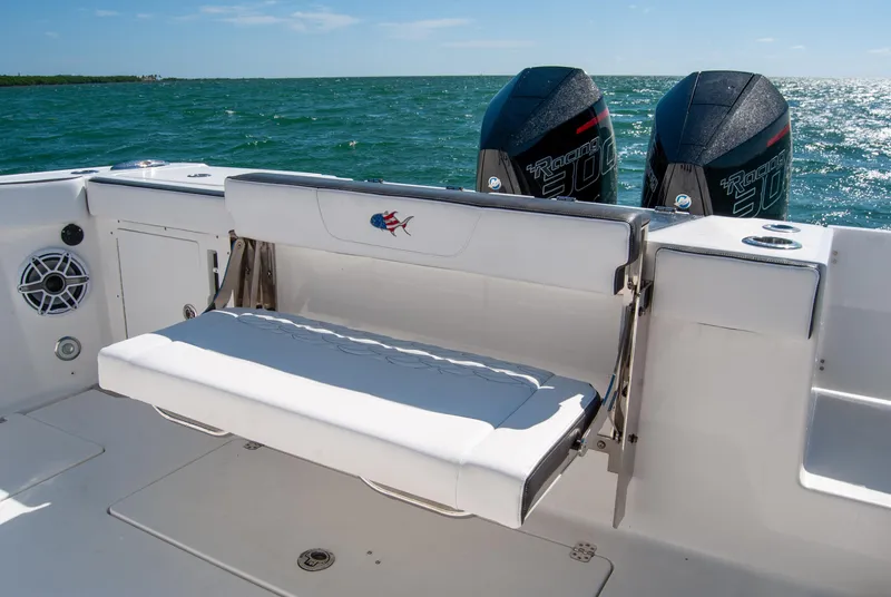 Slide: The Image of 2023 Crevalle 33 CSF boat with foldable seat and twin outboard motors on open water. - 15