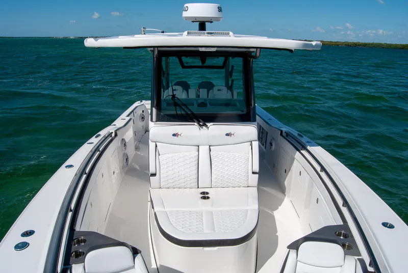 Slide: The Image of 2023 Crevalle 33 CSF boat on water, featuring sleek design and spacious seating. - 23