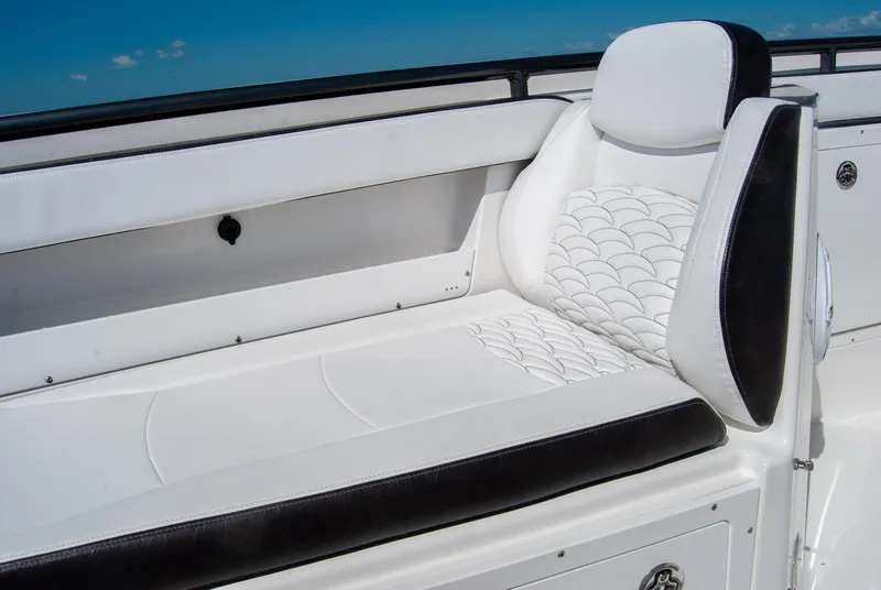 Slide: The Image of 2023 Crevalle 33 CSF boat with white and black cushioned seating. - 28