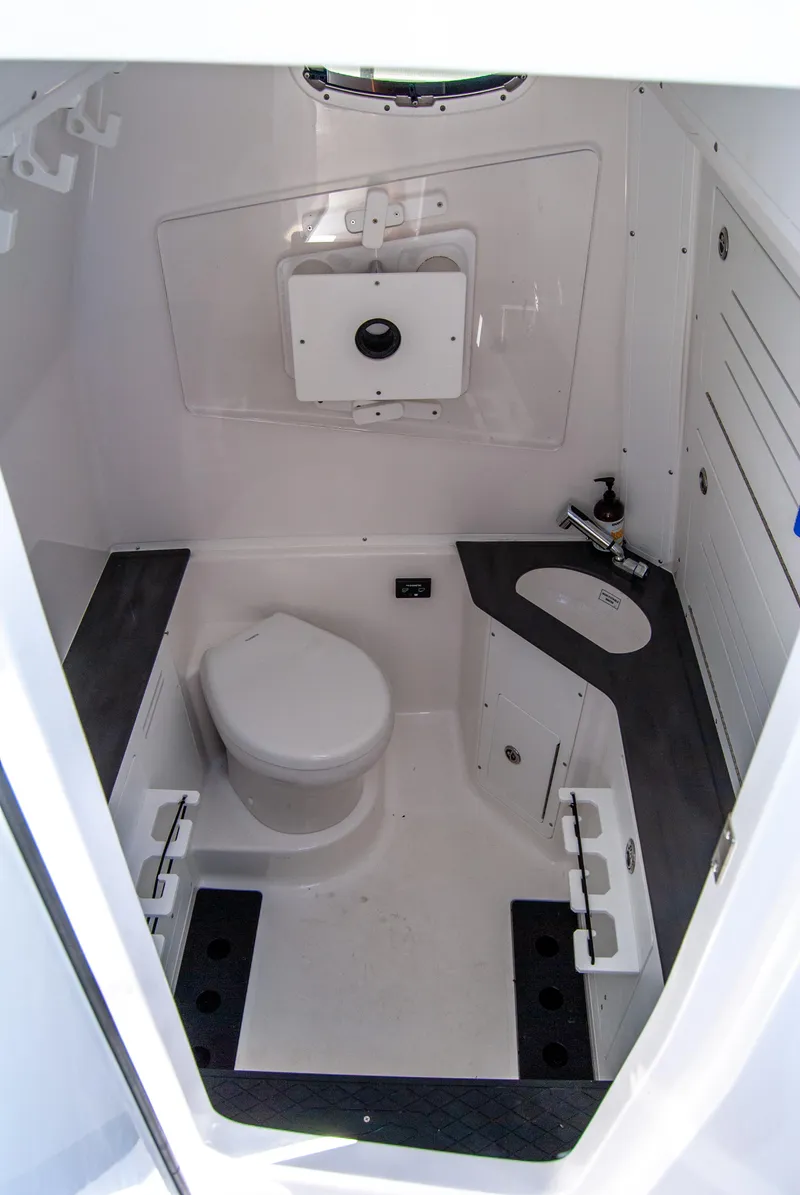 Slide: The Image of 2023 Crevalle 33 CSF boat interior bathroom with toilet and sink. - 34