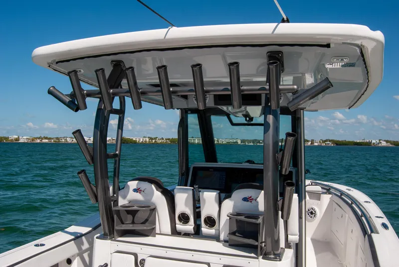 Slide: The Image of 2023 Crevalle 33 CSF boat with rod holders, on calm blue water. - 38