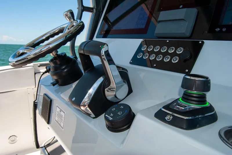 Slide: The Image of Control panel of 2023 Crevalle 33 CSF boat with steering wheel and throttle. - 40