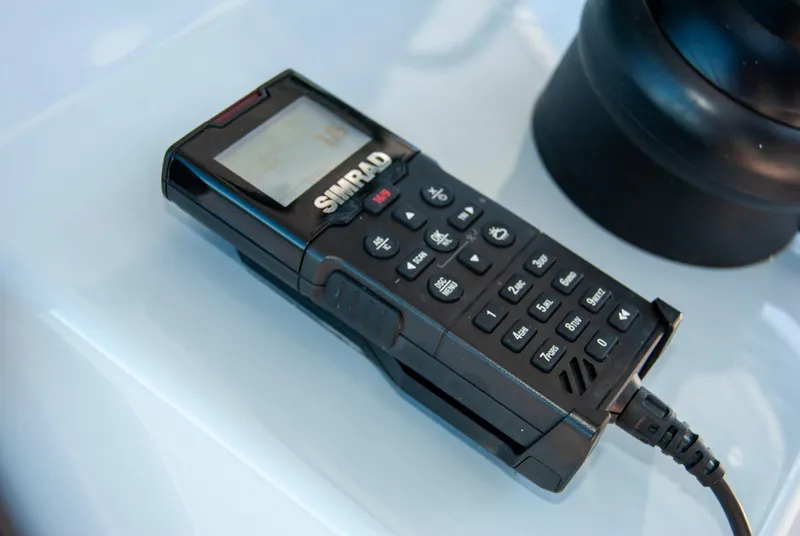 Slide: The Image of Simrad marine radio on Crevalle 33 CSF 2023 boat, featuring a sleek black design. - 41