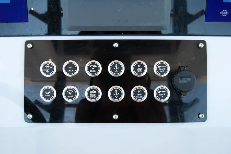 Slide: The Image of Control panel of 2023 Crevalle 33 CSF boat with labeled buttons and switches. - 42