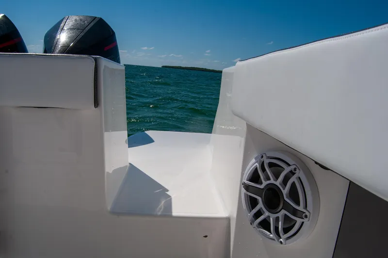 Slide: The Image of 2023 Crevalle 33 CSF boat interior with speaker, ocean view, and dual engines. - 48