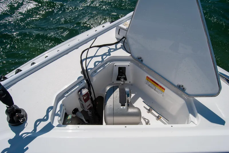 Slide: The Image of 2023 Crevalle 33 CSF boat anchor compartment with open hatch on water. - 50