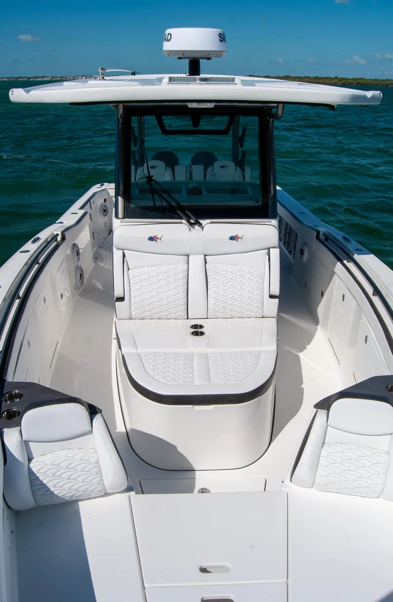 Slide: The Image of 2023 Crevalle 33 CSF boat with sleek design on open water. - 58
