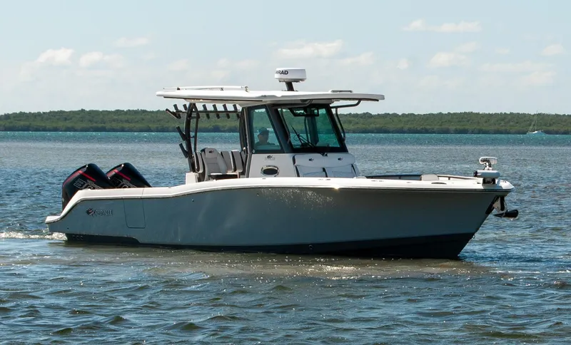 Slide: The Image of 2023 Crevalle 33 CSF boat cruising on calm waters under a clear sky. - 65