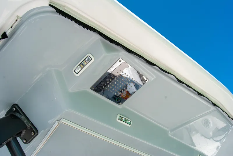 Slide: The Image of 2023 Crevalle 33 CSF boat interior detail with control panel and blue sky background. - 7