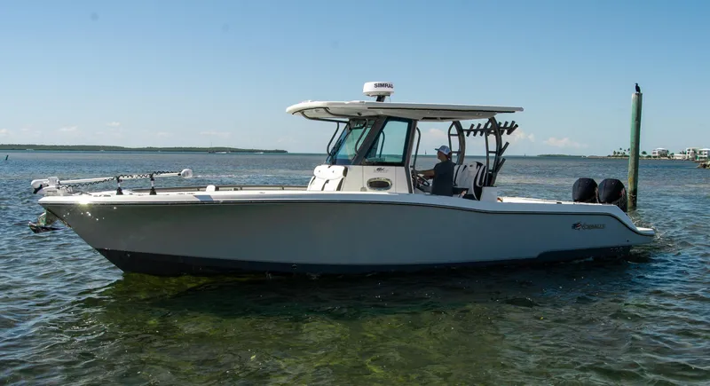 Slide: The Image of 2023 Crevalle 33 CSF boat on calm water, side view, clear sky background. - 73