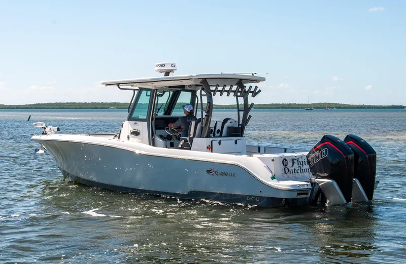 Slide: The Image of 2023 Crevalle 33 CSF boat on water with dual engines, side view. - 74