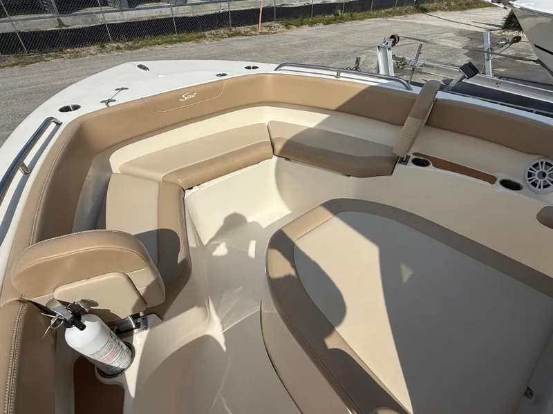 Slide: The Image of 2023 Scout 215 XSF boat interior with beige seating and safety equipment. - 17