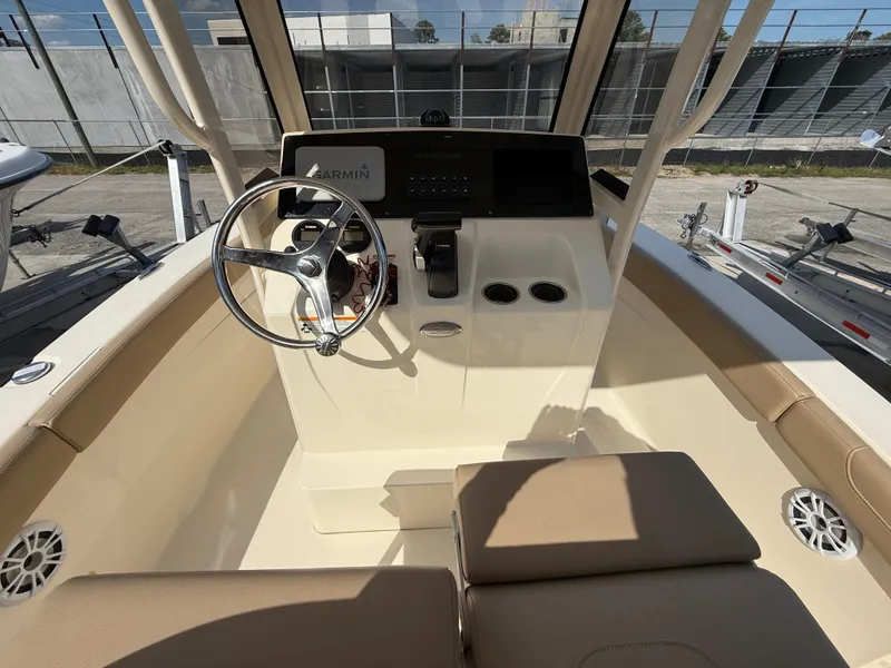 Slide: The Image of 2023 Scout 215 XSF boat interior with steering wheel and control panel. - 19