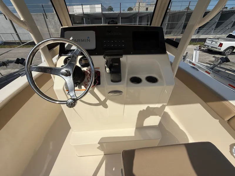 Slide: The Image of 2023 Scout 215 XSF boat helm with steering wheel and Garmin navigation system. - 20