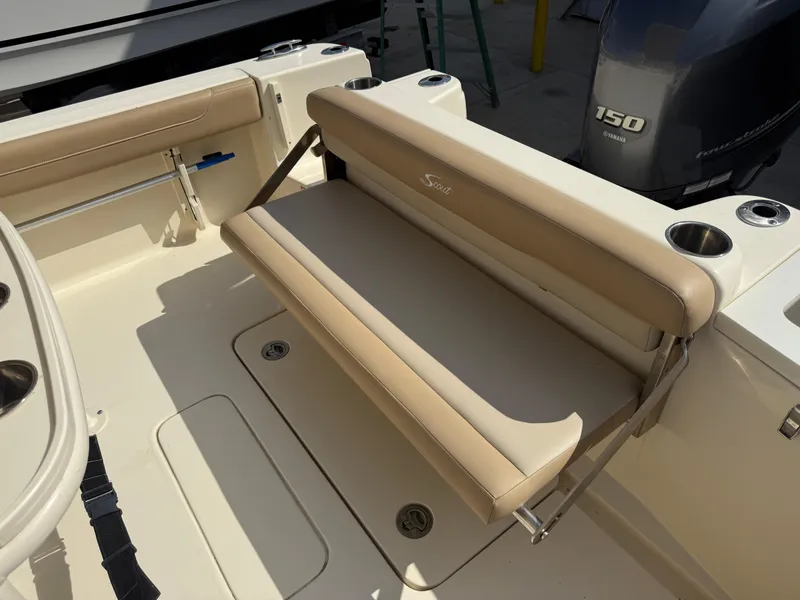 Slide: The Image of 2023 Scout 215 XSF boat interior with beige seating and cup holders. - 21