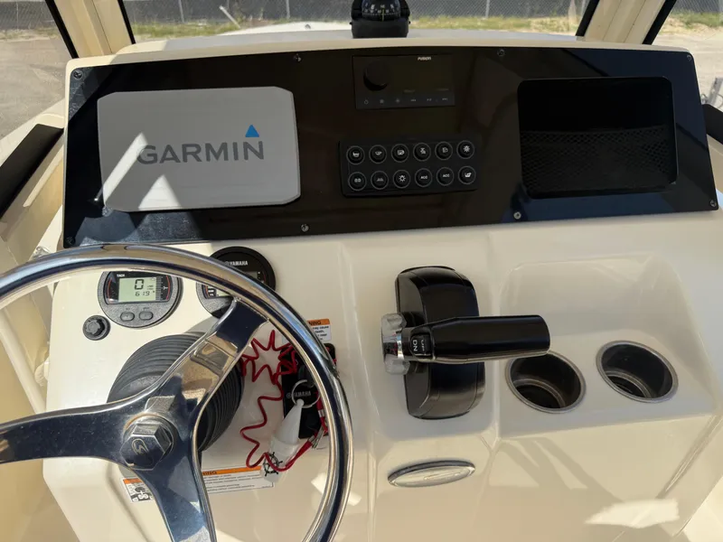 Slide: The Image of 2023 Scout 215 XSF boat dashboard with Garmin navigation system and steering wheel. - 25