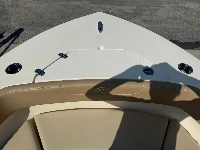 Slide: The Image of 2023 Scout 215 XSF boat bow with beige seating and cup holders. - 30