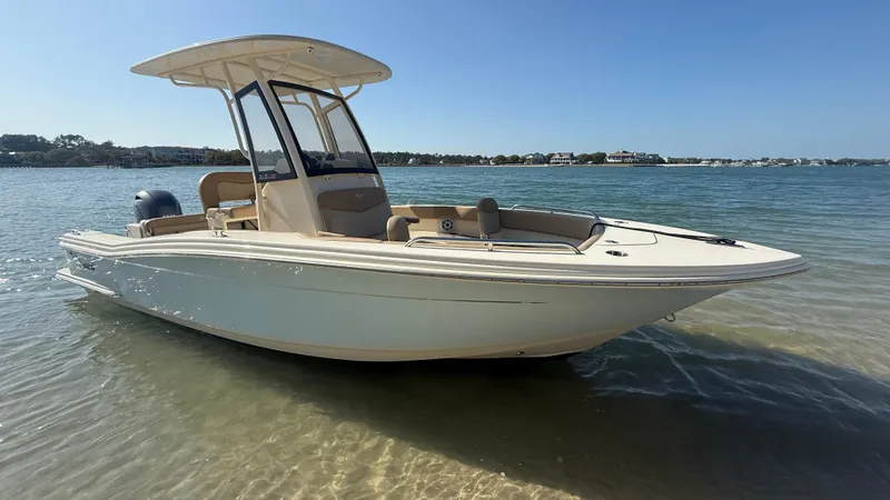 Slide: The Image of 2023 Scout 215 XSF boat in shallow water, clear sky background. - 31