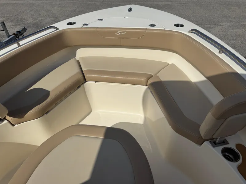 Slide: The Image of 2023 Scout 215 XSF boat interior with beige seating and cup holders. - 32