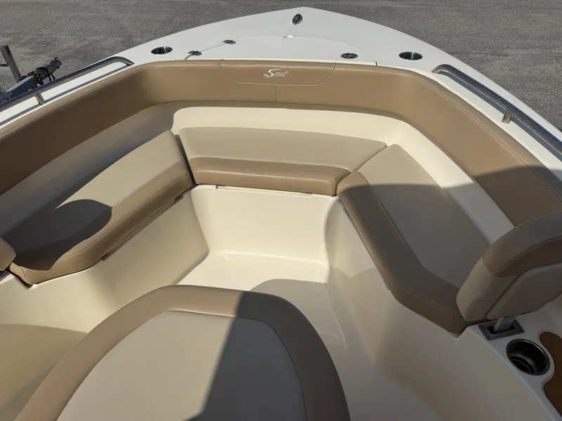 Slide: The Image of 2023 Scout 215 XSF boat interior with beige seating and cup holders. - 33