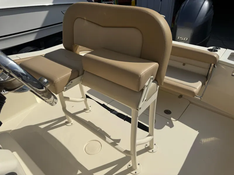 Slide: The Image of 2023 Scout 215 XSF boat interior with beige seating and steering wheel. - 36