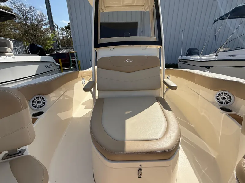 Slide: The Image of 2023 Scout 215 XSF boat interior with beige seating and console. - 39