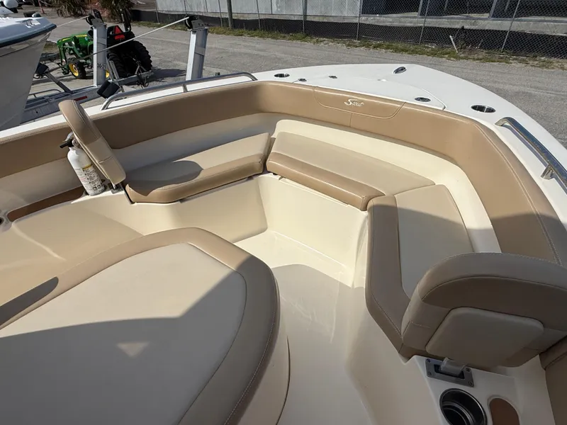 Slide: The Image of 2023 Scout 215 XSF boat interior with beige seating and cup holders. - 43