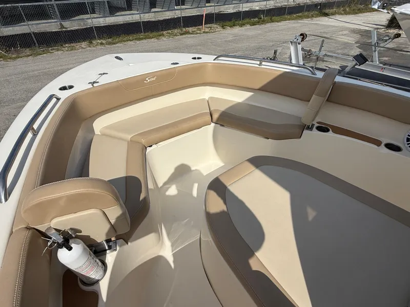 Slide: The Image of 2023 Scout 215 XSF boat interior with tan seating and fire extinguisher. - 46